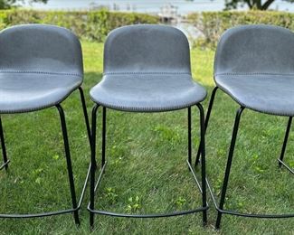 Three CB2 Primitivo Grey Counter Stools In Italian Leather Designed By Omar De Biaggio