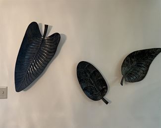 Large metal leaves. Wall mounted but could be on table, they have feet