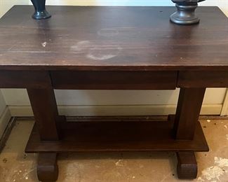 This vintage table is STOUT! Very cool lines and a small drawer along the side.