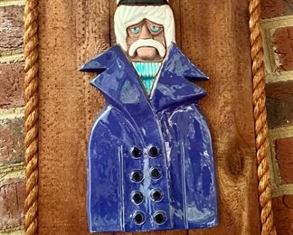 Coastal style, clay image on wood with rope edge.