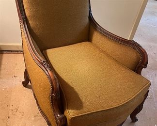 This chair------awesome! Comfy, sturdy, and the brass tacks are the perfect design addition. Look at the detailed woodwork on this beauty.