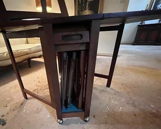 The roll-away hidden compartment that houses all four chairs. Extra company coming for dinner and there is no room at the dining table?? NO PROBLEM! Just open up this space-saving cutie and problem solved.