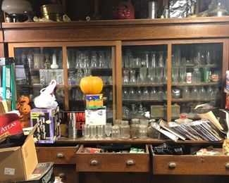 Large old drug store display full of collectible glasses and misc old bottles 