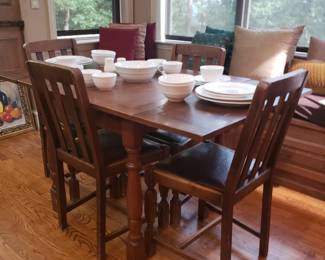 Wood dining / game table w 4 chairs...leaves on sides push in.