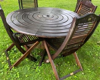 Round teak table with 4 chairs.