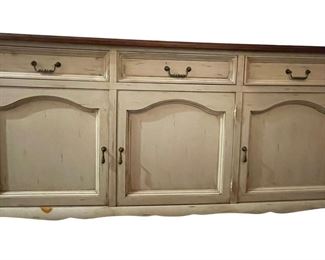 MAKE OFFER.  ALL OFFERS CONSIDERED.  $1000 USD      French Country Distressed White Arch Door Buffet Sideboard Credenza LA178-35    A French painted sideboard cabinet from the mid 20th century. This mid-century cabinet from Italy, features a rectangular-shaped dark wood top with overhanging, molded edge, atop a case which houses three panel-front drawers set horizontally. Each door is arch-shaped and open to reveal a shelf and plentiful storage within. This piece has a white wash which still shows much of the natural wood grain. This mid 20th century French console cabinet, with it's great length and storage potential, would work well in a dining or kitchen area as a buffet, or perhaps as a nice storage piece for a family room.
Dimensions: 69.5 x 20 x 36"H
Condition: Very good
Local pick up Potomac, MD.  Contact us for shipper suggestions     https://goodbyhello.com/products/french-country-distressed-wht-arched-door-buffet-sideboard-credenza-la178-35?_pos=8&_sid=f4cf1db7b&_ss=r