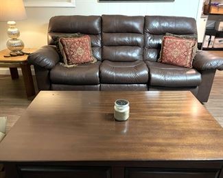 Brown leather sofa recliner and wood coffee and side tables