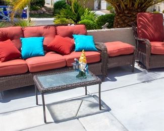 Outdoor couch, foot rest, swivel chair, and glass top table