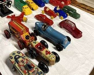 Plastic, glass, tin and cast iron transportation. The blue race car is Hubley.