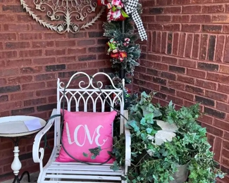 Cast iron chair and table, metal wall art, lighted lamppost and metal decorative wheelbarrow