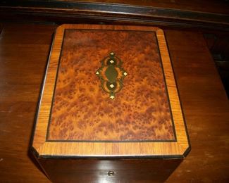 Inlaid box with ebony trim and inlaid brass decoration.