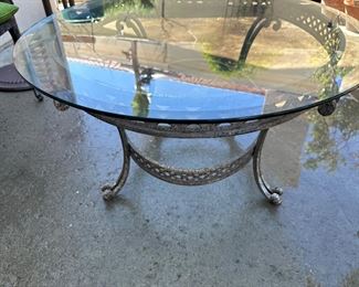 Oval beveled glass top metal patio coffee table measures 49 x 37 inches, 19.5 high