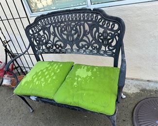 Sweet black metal garden patio loveseat with makeshift green cushions, deserves better