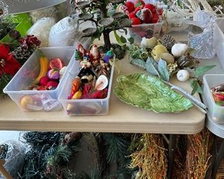 Bins full of holiday lights, these all clear, holiday garlands with  crystal details, fall harvest wreaths,  tall egg holder for Easter, deluxe ornaments, leaf tray, 
