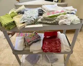 Mostly napkin sets here, and white buffet tablecloths by the dozen