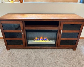 Twin-Star glass bottom electric fireplace in excellent condition.  64”W x 20”D x 30 1/2”T