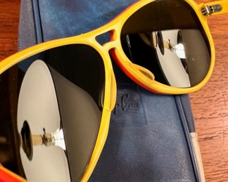 Vintage Ray-Ban Vagabond Sunglasses in rare Red-Orange-Yellow color combo.  This pair features the Olympic Rings as they were issued right after the US Olympic Committee selected Ray-Ban to outfit US Olympians & comes with original case and info cloth