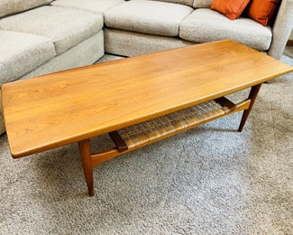 Vintage Moreddi teak surfboard coffee table with rattan shelf.  55”W x 20 1/2”D x 16”T