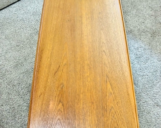Vintage Moreddi teak surfboard coffee table with rattan shelf.  55”W x 20 1/2”D x 16”T