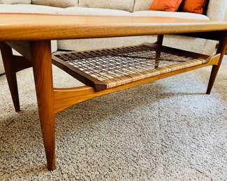 Vintage Moreddi teak surfboard coffee table with rattan shelf.  55”W x 20 1/2”D x 16”T