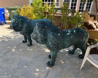 European bronze  lions.  Circa 1960s.  Each lion weighs over 300 lbs. and stands 44" tall  /  60" long.  This pair of lions were removed from an English Manor House and imported from England in the 1980's. 