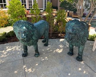 European bronze  lions.  Circa 1960s.  Each lion weighs over 300 lbs. and stands 44" tall  /  60" long.  This pair of lions were removed from an English Manor House and imported from England in the 1980's. 