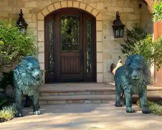 European bronze  lions.  Circa 1960s.  Each lion weighs over 300 lbs. and stands 44" tall  /  60" long.  This pair of lions were removed from an English Manor House and imported from England in the 1980's.  