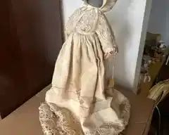 Faceless doll with antique fabric dress