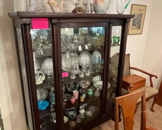 A large 1900s Empire china cabinet filled with early American glassware, antique mercury glass, flow blue, American cut crysals and much more