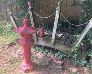 Yard Art including:  Hand Crafted Wood Bridge with Railing out of Chains and Wood Posts; Oriental Pagoda on Pedestal Painted Red; and Foo Dog Statuary Painted Red; and Red Bricks 