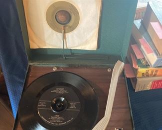 Vintage Record Player with bakelite platter.  Comes with Records you See Here. Approximately 12-14" square.  Metal Exterior Cabinet.