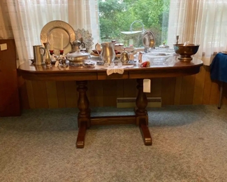 Oval Wood Trestle Dining Table in Beautiful Condition.  No Chairs.  Assortment of pewter, aluminum, ceramic, glass and silver plate.