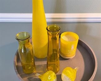 Grey side table and shown with yellow glass decor