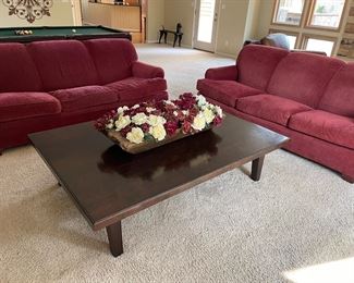 Wood cocktail table with matched set of 3-cushion couches