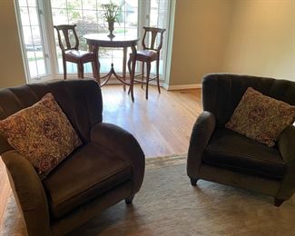 Velvet club chairs - matched set and in the background high-top marble-topped table with leather seated chairs