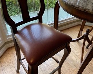 Another view of the leather chairs with high-top marble table