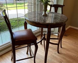 Marble topped high-top cocktail table with 2 chairs with leather seats