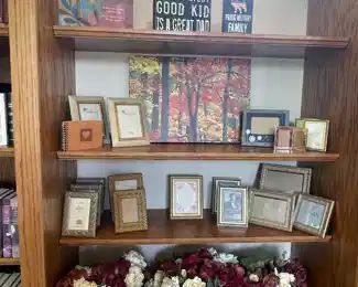 Picture frames, faux floral arrangements, and artwork