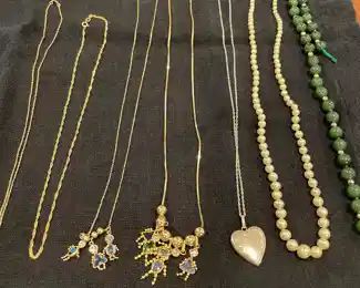 Gold necklaces, sterling silver locket, pearl and jade with gold necklace