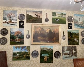 An art wall of Will Marick's paintings, pewter plates & More