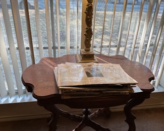Antique turtle-top table with old newspapers capturing headlines of yore