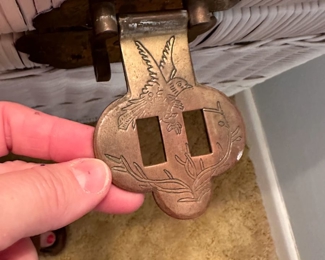 Detail of brass lock on white wicker trunk