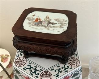 Close up of the garden bench and an early Chinese plant stand with a porcelain tile that depicts Laozi, the Father of Taoism riding on a water buffalo with his disciple .  Early 19th century or late 18th.  $500. That's a good deal 