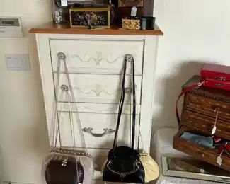 We have an abundance of Judith Lieber bags, a lingerie chest , and sone precious jewelry boxes inlaid with jade and marquetry.  