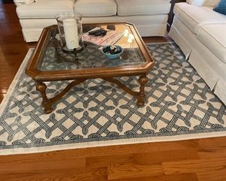 . . . glass coffee table with area rug