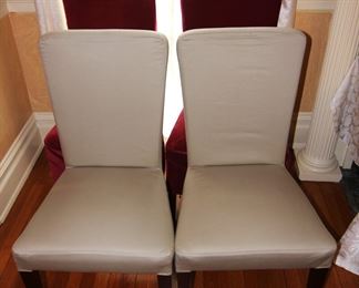 Twelve Pottery Barn Chairs with slipcovers.