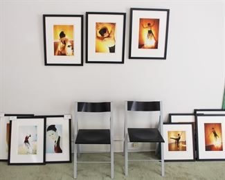 Pair black folding chairs, framed photos.