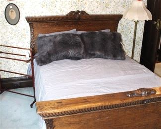 Antique tiger oak bed with wonderful carvings.                 63" W x 81" L x 47" H. Shown with bedding by LeBon Marche, Paris.