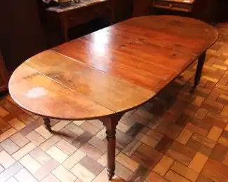Oak Round Table, five Legs, eight Leaves.                               77" L x 44" W x 28 1/2" H. Six Leaves are 14" W.