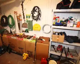Assortment of garden tools, shovels, rakes, hoses, trimmers and more.